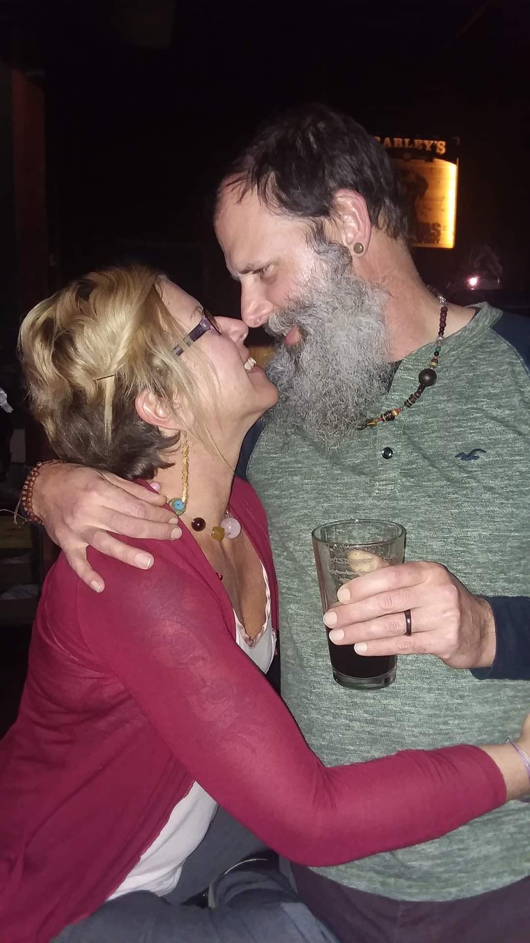 a middle aged man looking into the eyes of a middle aged woman